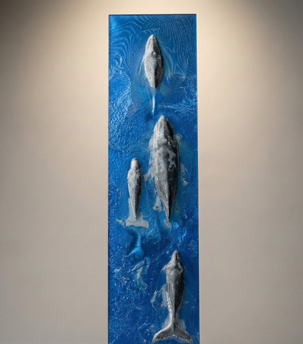 3D-printed whale lithopane panel showing whales breaking the ocean surface, made with blue, black, and white filaments